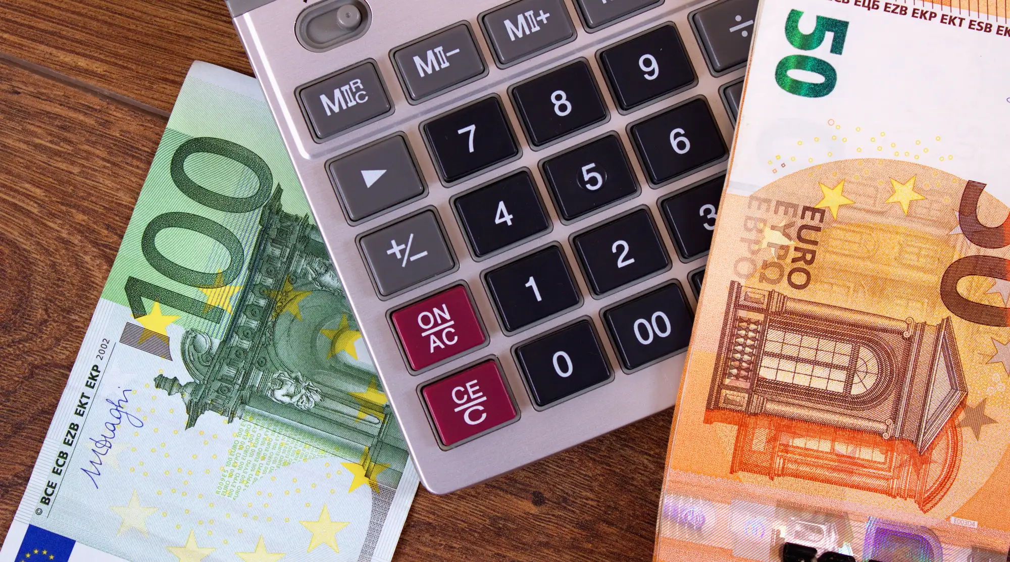 Kalkulator i banknoty euro symbolizujące niewypłaconą pensję